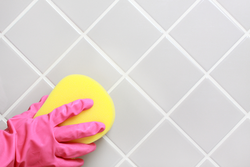 Hand,And,Glove,Cleaning,The,Bathroom,Tiles.